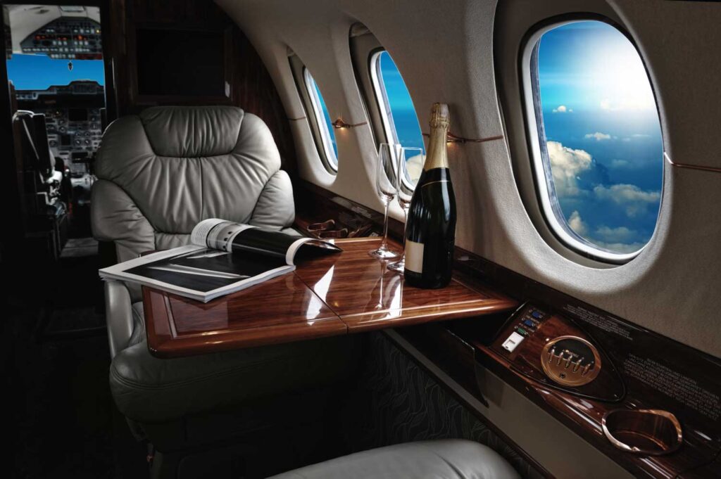 How to grow your wealth without mistakes - champagne bottle on a private jet